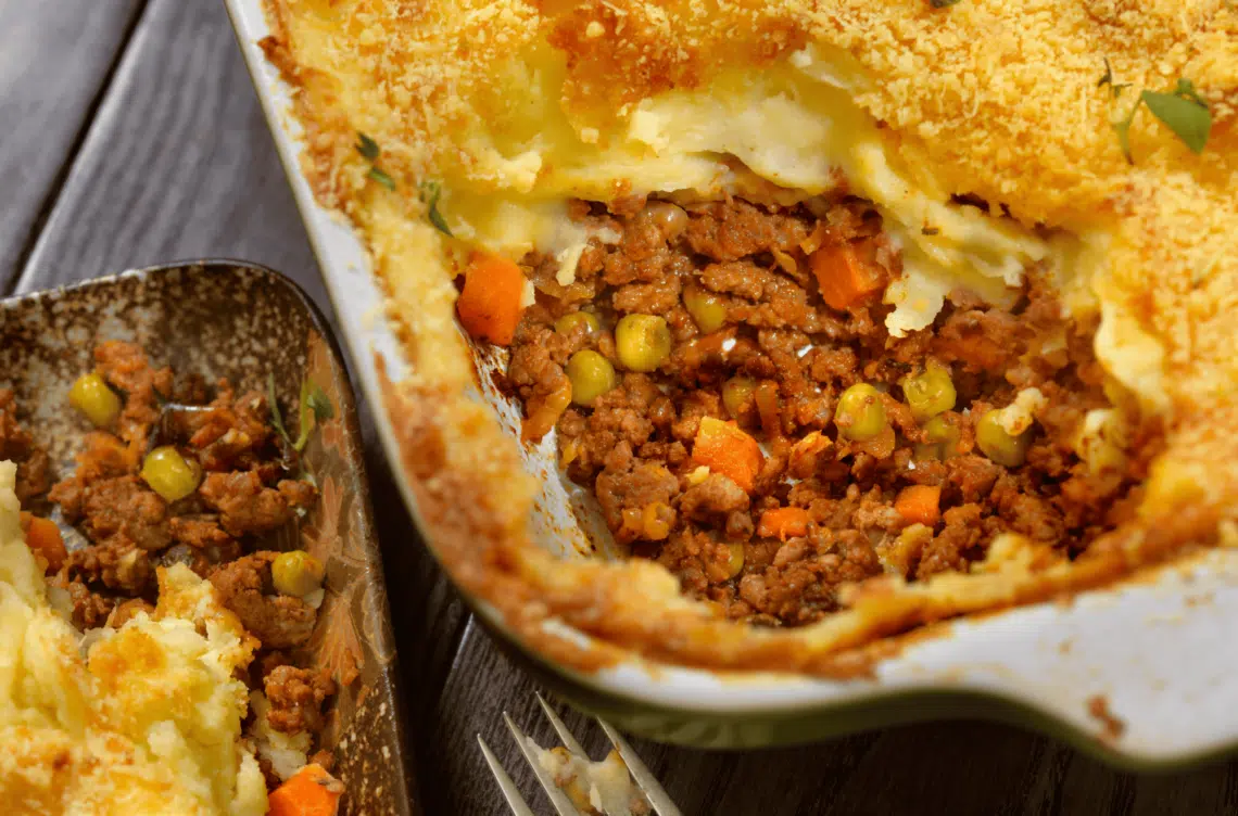 A Pan Of Lighter Shepherd'S Pie, Sliced, Exposing The Delicious Filling