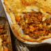 A pan of Lighter Shepherd's Pie, sliced, exposing the delicious filling