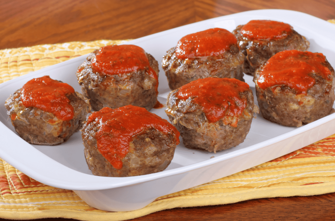 Seven Mini Turkey Meatloaf Balls On A White Serving Plate