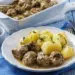 Swedish Meatballs With Peeled Boiled Potatoes Om A White Plate