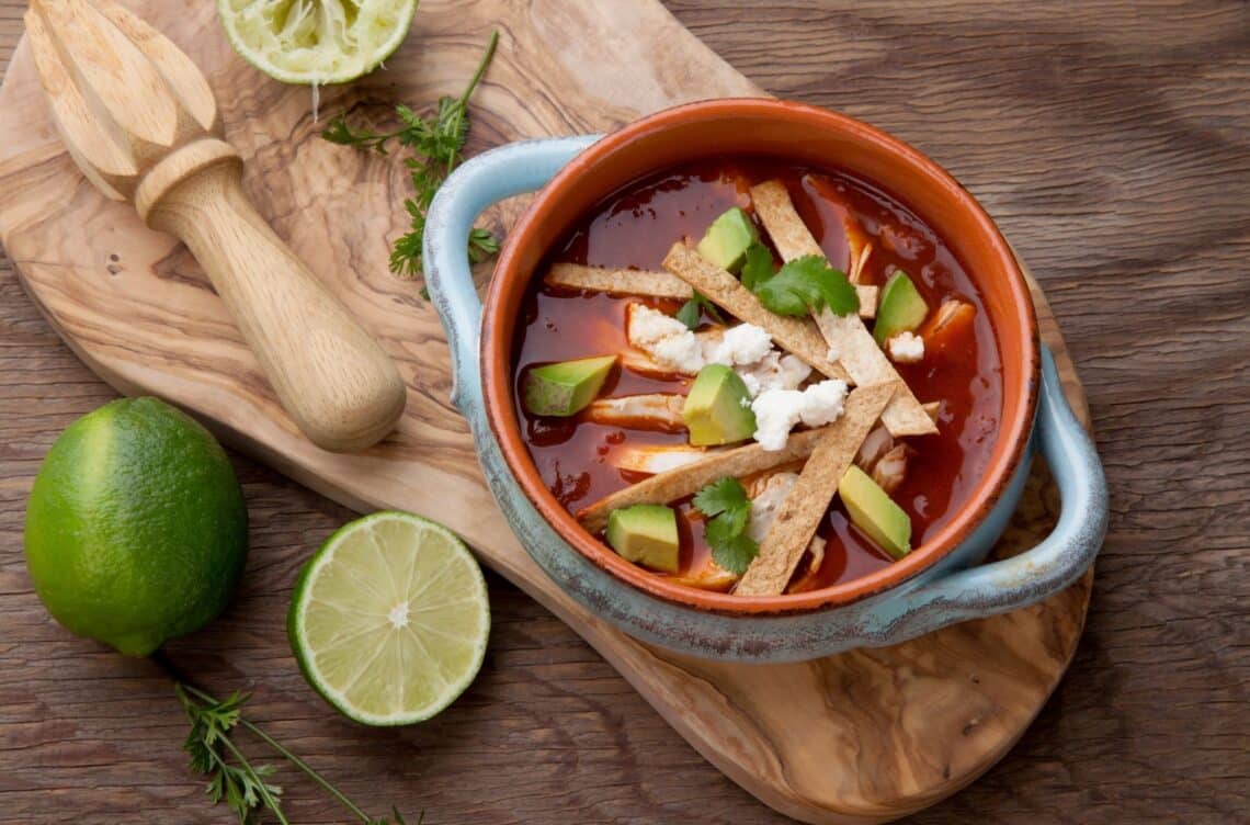 Healthy And Easy Chicken Tortilla Soup In A Bowl With Sliced Lime On The Side