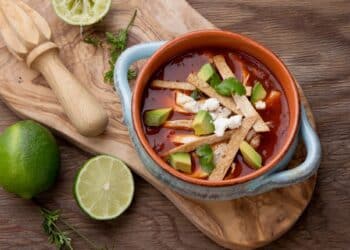 Healthy And Easy Chicken Tortilla Soup In A Bowl With Sliced Lime On The Side