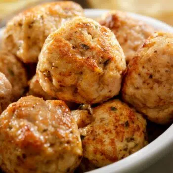 A Bunch Of Tasty And Easy Sesame-Spiced Turkey Meatballs In A White Bowl