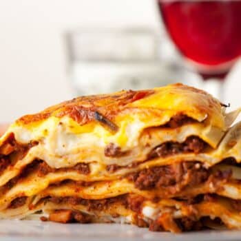 The Best Lasagna Recipe In The World served with wine and salad