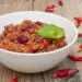 The Perfect Chili Recipe In A White Bowl With Chilis Around