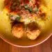 Slow Cooker Healthy Turkey Meatballs Over Spaghetti Squash Served On A Yellow Plate