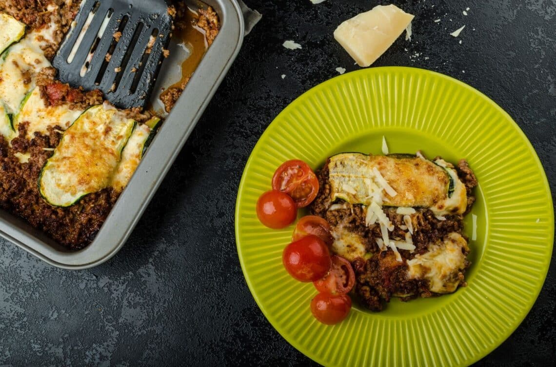 A Slice Of The Ultimate Low-Carb Lasagna On A Green Plate