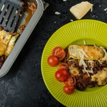 A Slice Of The Ultimate Low-Carb Lasagna On A Green Plate