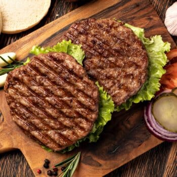 Best Grilled Burgers With Buns, Pickles, And Slide Tomato On The Side