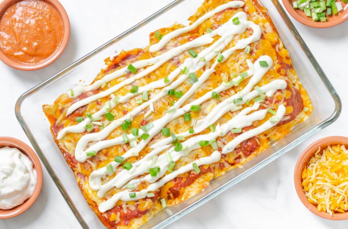 Tempting Mexican Enchiladas with Bell Pepper-Tomato Sauce Served With Cheese, and Sour Cream