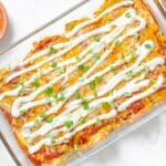 Tempting Mexican Enchiladas With Bell Pepper-Tomato Sauce Served With Cheese, And Sour Cream