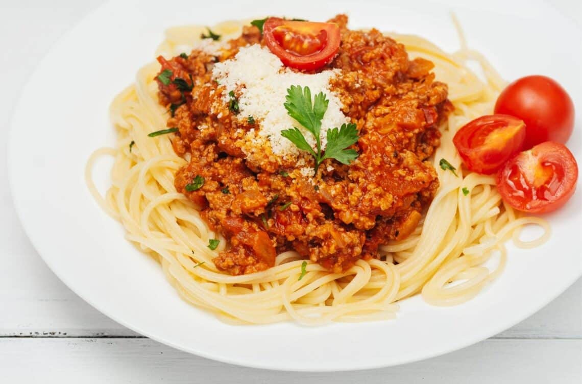 My Secret Bolognese Ragu Sauce Served With Sliced Tomatoes