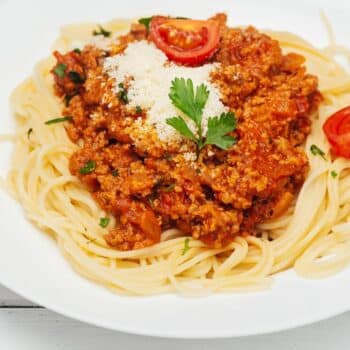 My Secret Bolognese Ragu Sauce Served With Sliced Tomatoes