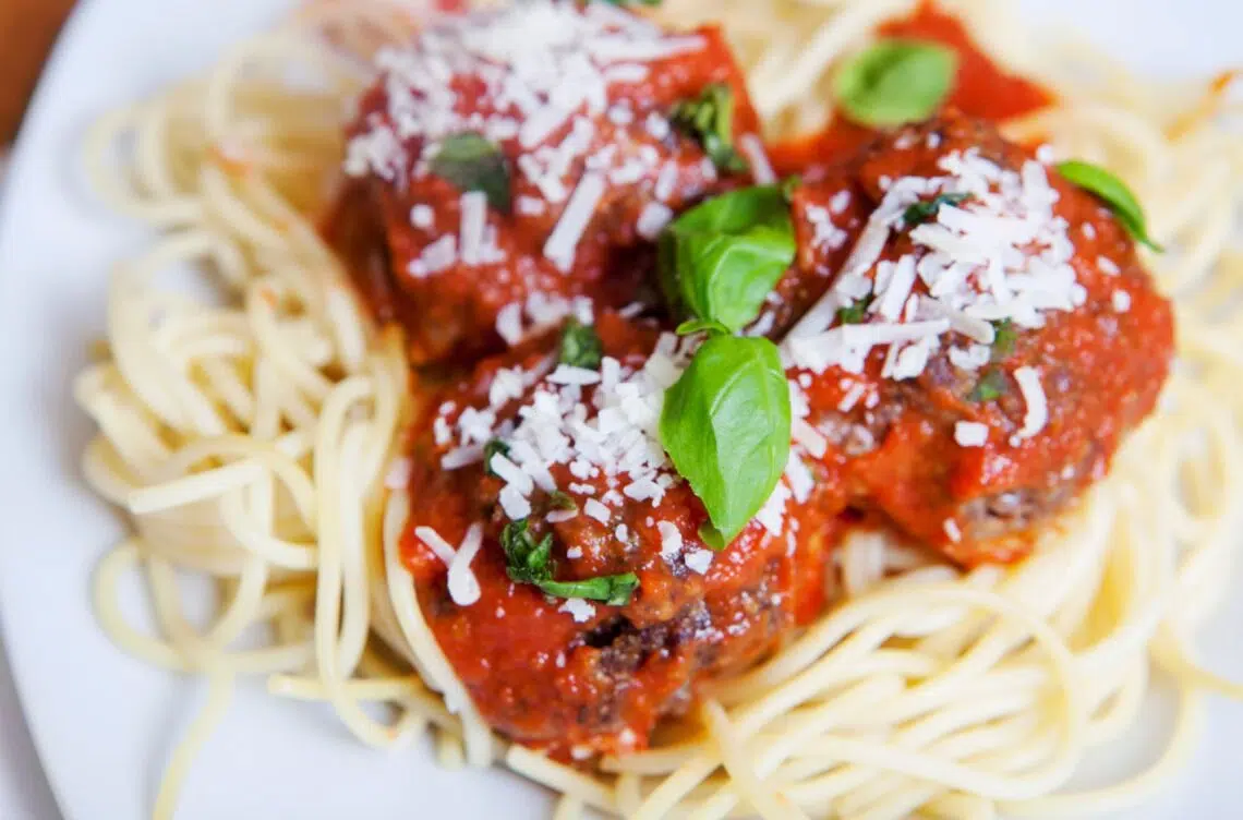 Super Easy Spaghetti And Meatballs With Parmesan Cheese And Basil On Top