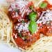 Super Easy Spaghetti And Meatballs With Parmesan Cheese And Basil On Top