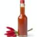 Bottle with hot chili pepper sauce and fresh tabasco peppers
