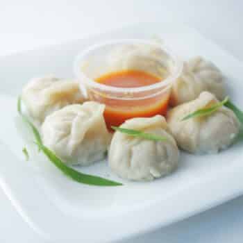 Hot, Steamy Chicken Momos With Spicy Sauce