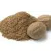 Heap Of Ground Nutmeg And Whole Nutmeg Seeds