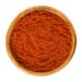 Sweet pepper red paprika powder in wooden bowl over white