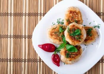 Easy Chicken Rissoles On A White Serving Plate With Chilis