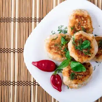 Easy Chicken Rissoles On A White Serving Plate With Chilis